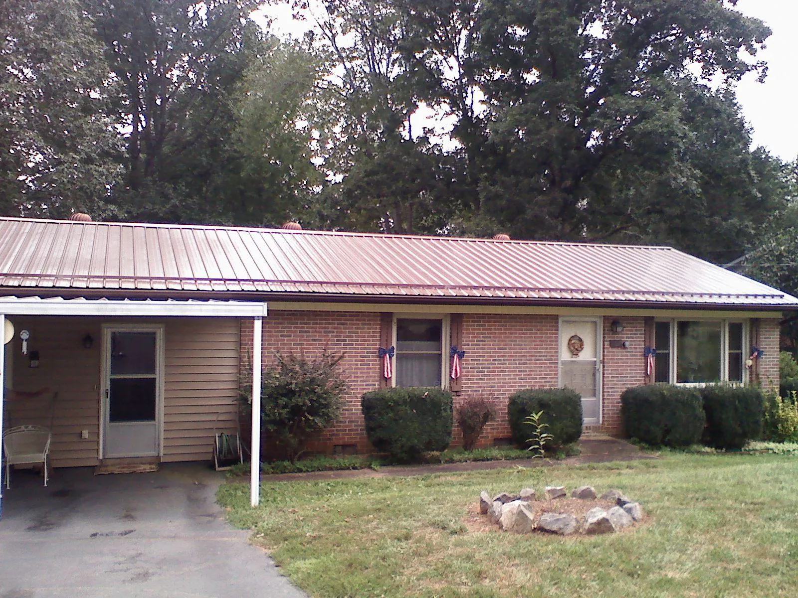 Bronze metal roof and carport on a brick ranch home — Roof Repair work by our crew in Hackettstown