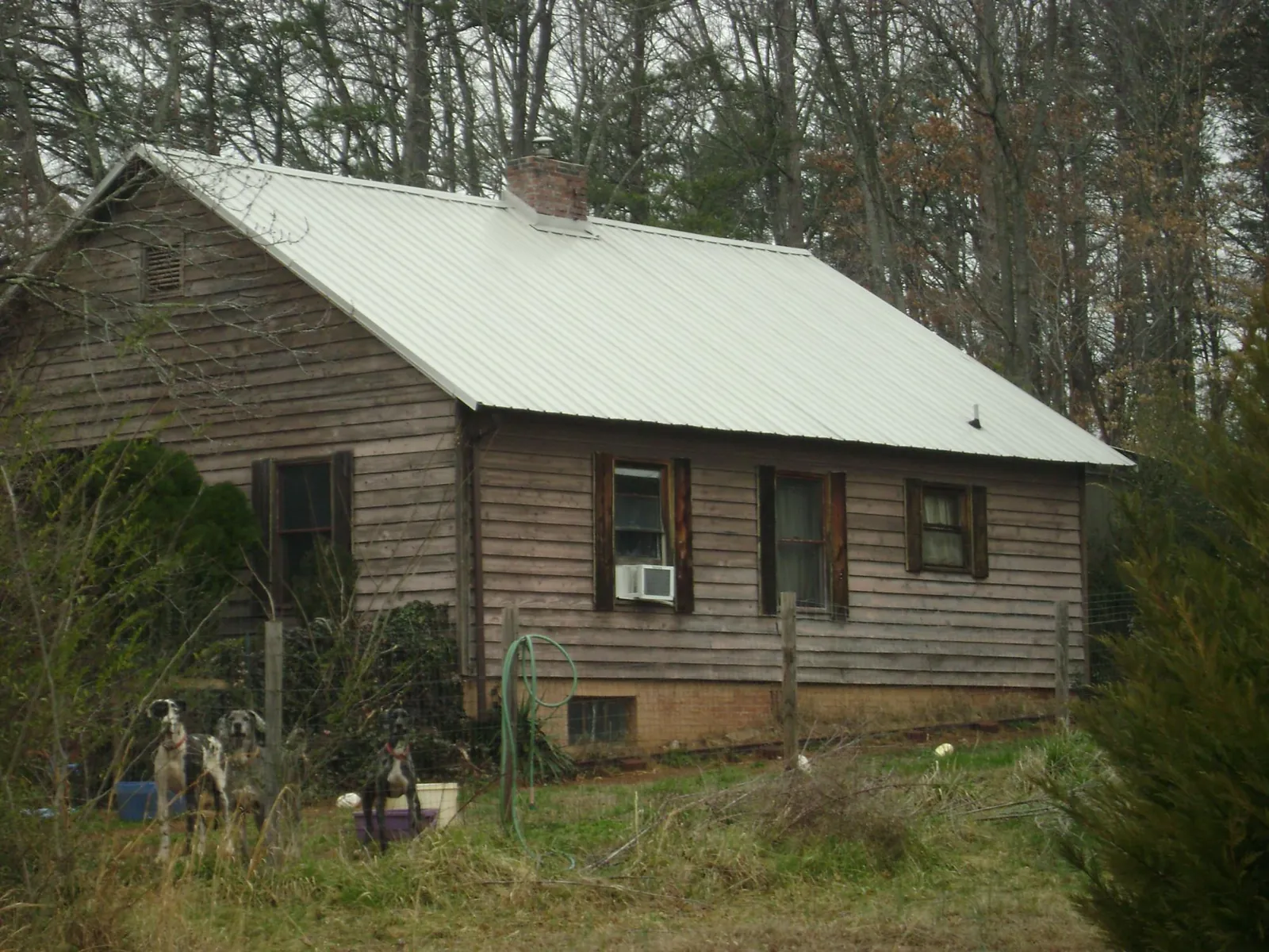 White metal roof on an old wood sided farmhouse, from a Metal Roof Installation job in Hackettstown